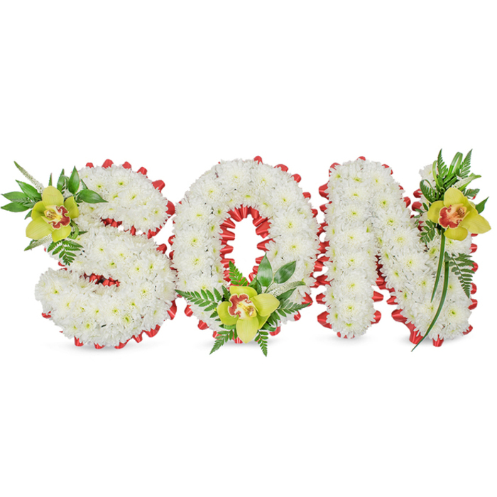 This elegant commemorative design forms the single word SON in bold, sculpted letters assembled from countless small white chrysanthemums, each blossom contributing to a seamless, pillowy surface. The white petals create a uniform, serene field while a neatly pleated red ribbon traces the perimeter of every letter, producing a scalloped, rhythmic border that punctuates the composition with warmth and visual clarity. Placed for emotional balance, three lime-green Cymbidium orchids anchor the arrangement: one resting near the upper left curve of the S, one cradled at the base of the O, and a third accenting the upper right of the N. The orchids' soft green-yellow tones and reddish-brown throat markings introduce subtle colour variation and a delicate, tactile sheen. Surrounding each orchid are sprigs of fresh green foliage and fine fern fronds that trail and lift, lending the piece a natural grace and gentle vertical movement against the smooth white backdrop. The soft studio lighting emphasises texture - the chrysanthemums' matte softness, the ribbon's satin sheen, the orchids' waxy glow, and the fragile filament of the ferns - creating an intimate, respectful impression. Intended as a personalized funeral or graveside tribute, this arrangement conveys tenderness, honour and remembrance. Local families in Shadwell and neighbouring Wapping or Limehouse often select this style for memorial services when they want a clear, heartfelt statement of love for a son.