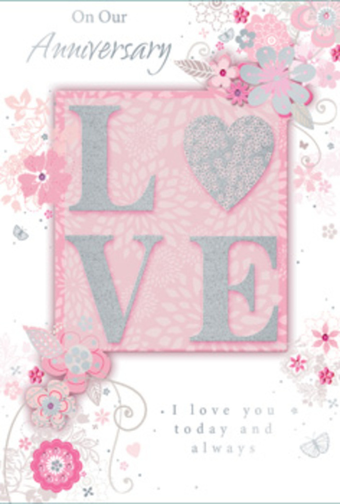 The photograph shows a beautifully detailed anniversary card that feels as serene and romantic as watching the riverlight flicker near Shadwell's shoreline. The primary focal point is the word LOVE, centred on the card and rendered in large, embossed letters. These letters are dusted with fine glitter in blush-pink, pearly white, and subtle silver hues, giving them a delicate sparkle. The glitter is smooth yet lightly textured, so that when you imagine running a finger across it, you can almost sense a soft, grainy resistance beneath the skin. This shimmering word sits on a pastel pink background that gradually deepens towards the edges, creating a tender glow that enhances the intimacy of the message. Surrounding LOVE is an intricate frame of drawn flowers and leaves, as if a florist had sketched a romantic bouquet around the sentiment. The blossoms are stylised with slender white and grey outlines, some petals hinted at with faint shading, giving the illusion of layered depth without compromising the card's airy lightness. Fine vines and leaves curl and arc delicately, imitating the natural drape of foliage in a hand-tied arrangement prepared for a Shadwell anniversary dinner. Occasional strokes of silver foil highlight petal tips and leaf edges, catching the light in a subtle, elegant way. Around the floral design, soft grey script spells out Anniversary phrases-gentle words of promise and devotion-that flow across the surface like thoughtful handwriting in a love letter. The card exudes warmth, sophistication, and quiet joy, perfectly suited to accompany a bouquet delivered locally to mark another year of shared life along London's East End.