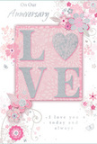 In this image, an anniversary card lies neatly displayed, its design blending soft pastel pinks and silvery greys into a tender expression of long-lasting love, much like the enduring stories behind many Shadwell couples. At its centre, the word LOVE is set in raised, block capitals, each letter thick with fine glitter that shifts between blush, pearl, and a faint silver sheen. The glittered surface appears gently textured, catching the light at different angles, so the word seems to softly glimmer rather than flash. Set against a velvety blush-pink background, the letters form a warm, inviting focal point. Around this, an arrangement of delicate illustrated flowers stretches outward in curved sprays, with petals and leaves drawn in graceful, fine lines of white and pale grey. There is a watercolour softness to the shading, suggesting the gentle layering of petals in a romantic bouquet a florist might prepare for a Shadwell anniversary surprise. Wispy vines and tendrils weave between the blooms, adding a sense of movement, as though a light breeze were passing over an English spring garden. Subtle accents of silver foil highlight select petals and leaf tips, creating glints of brightness that echo the shimmer of evening lights along nearby Wapping and Limehouse. Complimentary script, reading sentiments such as On Our Anniversary and I love you today and always, is set in an understated, flowing typeface that echoes handwritten notes. The entire composition feels softly celebratory and deeply heartfelt, the paper equivalent of a cherished bouquet delivered to a Shadwell doorstep for a quiet, meaningful anniversary at home.